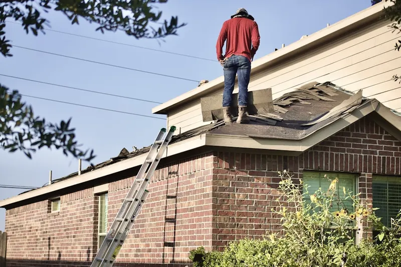 Professional roofer working on a residential roof in Saddle Ridge